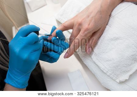 Close-up Of Professional Making Manicure With  Transparent Glossy Acrilyc . Specialist Beautician In