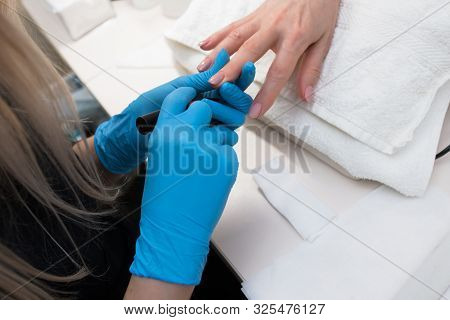 Close-up Of Professional Making Manicure With  Transparent Glossy Acrilyc . Specialist Beautician In