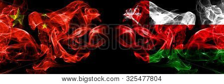 China Vs Oman, Omani Smoke Flags Placed Side By Side. Thick Colored Silky Smoke Flags Of Chinese And