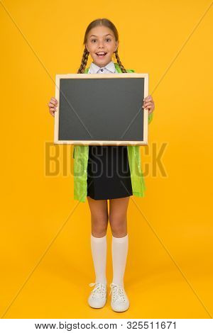 Schoolgirl Wear Raincoat Hold Blank Chalkboard Copy Space. Waterproof Fabric For Comfort. Rainproof 