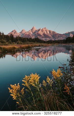 Sunrise On Teton Range Of The Rocky Mountains. Schwabacher Landing In Grand Teton National Park, Wom