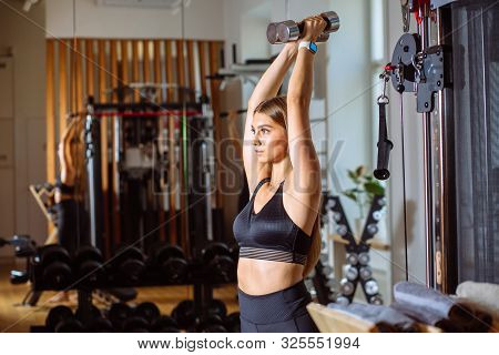 Side View Of Attractive Shape Young Sporty Focused Fitness Woamn In Black Sportswear With Ponytail D
