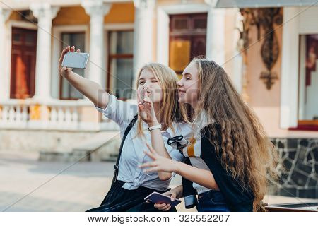 Happy Brightful Positive Moments Of Two Stylish Girls Hugging On Street In City. Closeup Portrait Fu