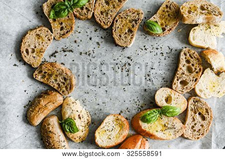 Oven Baked Bruschetta With Basil And Olive Oil In The Oven. Traditional Italian Appetizer. Top View