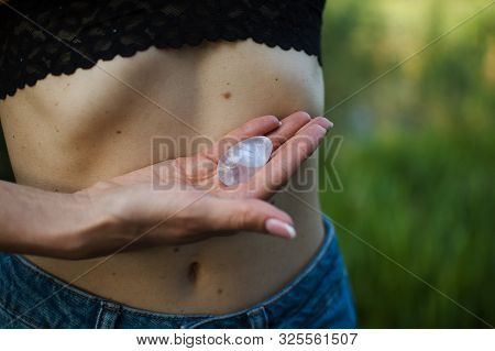 Adult Woman Is Holding Transparent Violet Amethyst Yoni Egg For Vumfit, Imbuilding Or Meditation Out