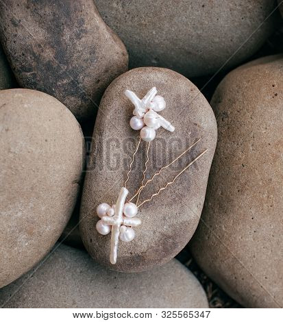 Beautiful stud earrings on the stone. Stock photo