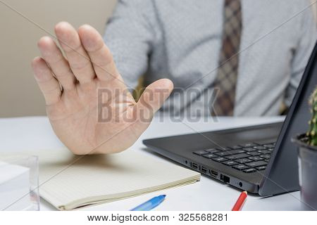 Business Man Show Hand Stop With Laptop Computer On Workingspace