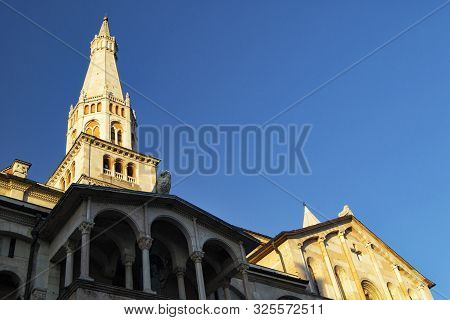 Ghirlandina Bells Tower And Facade Of The Duomo Of Modena With Blue Sky - 700 Years Fron The Constru