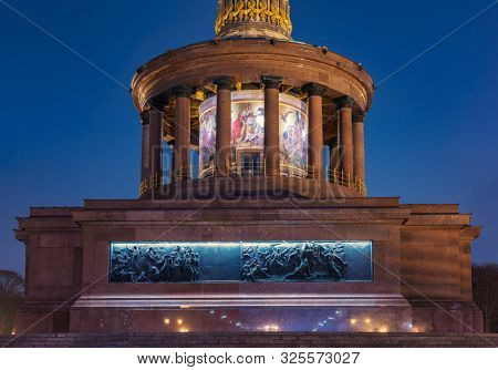 BERLIN, GERMANY - DECEMBER 15, 2018: Illuminated Berlin Victory Column (Siegessaule) monument hall of pillars with glass mosaic at night