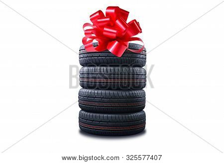 New Tires Pile As A Gift  Isolated On White. Tyres Pile With A Big Red Bow, As A Present Or Bonus Fo