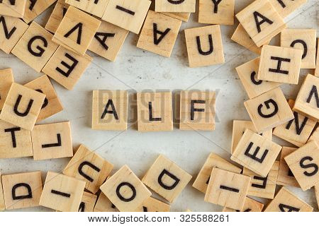 Top Down View, Pile Of Square Wooden Blocks With Letters Alf (stands For Always Listen First) On Whi