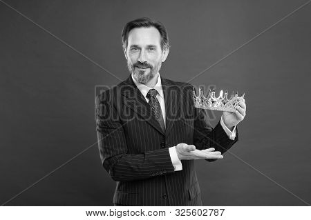 Man Bearded Guy In Suit Hold Golden Crown Symbol Of Monarchy. Become King Ceremony. Award And Achiev
