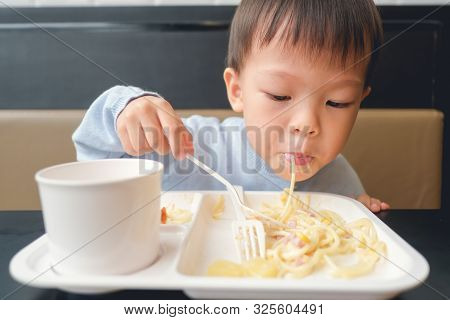 Cute Little Asian 3 - 4 Years Old Toddler Boy Toddler Boy Child Eating Spaghetti With Spoon And Fork