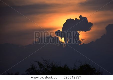Sun Rise And Sun Set Background, Yellow, Black And Orange Clouds In The Sky..
