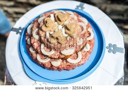 Wedding Cake Raw Ground Pork Cuisine Burgers On Tray With Onion, Rosemary And Bread Served On A Wedd