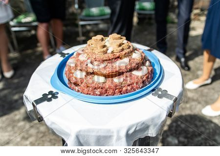 Wedding Cake Raw Ground Pork Cuisine Burgers On Tray With Onion, Rosemary And Bread Served On A Wedd