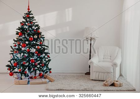 Christmas Tree With Christmas Gifts In White Hall On Christmas