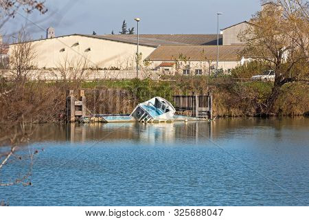 Capsize Boat Near Dock At Channel Waterway