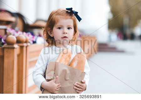 Funny Baby Girl 3-4 Year Old Dancing Outdoors Wearing Dress And Hat Closeu. Looking At Camera.