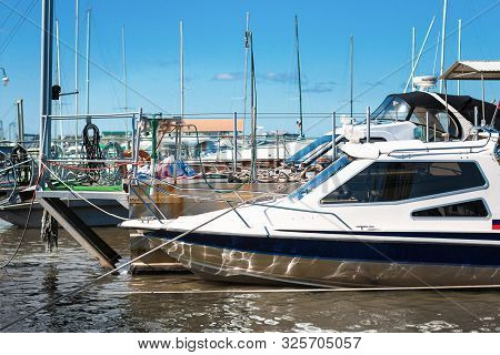 High-speed Boat On The Pier In Sunny Day. Yacht Parking In A Bay
