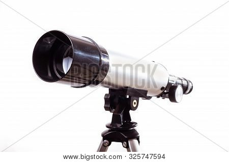 Telescope On A White Background Laid On A Rough Wooden Board