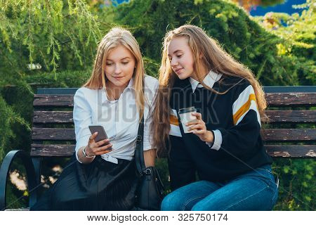 Happy Brightful Positive Moments Of Two Stylish Girls Hugging On Street In City. Closeup Portrait Fu