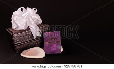Decorated Brown Lether Box With Silver Ribbon And Happy Anniversary Mini Message Book With Seashell 