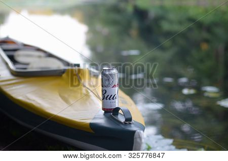 Sumy, Ukraine - August 10, 2019: Budweiser Bud Beer Can On Yellow Kayak Outdoors In The River And Gr