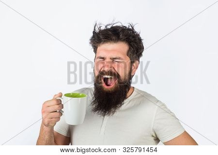 Yawning Man With Sleepy Face Try To Awake With Cup Of Coffee. Man Hold Mug With Hot Drink. Man With 