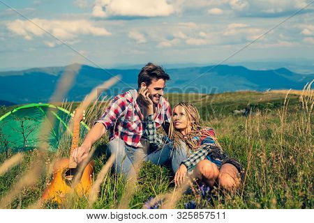 Smiling Woman Flirt With Handsome Man At The Mountainside Having Rest At The Nature. Travel Couple E