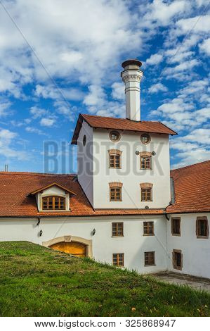 Dacice, Czech Republic - September 29 2019: View Of Former Brewery Building With White Facade, Red R
