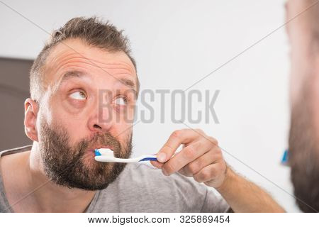 Funnny Guy Taking Care Of His Oral Hygiene, Brushing Teeth During Morning Bathroom Routine.