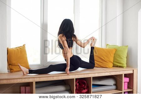 Back View Of Yogi Practicing Complex Monkey Pose, Looking In Window. Fitness, Training, Gym And Spor