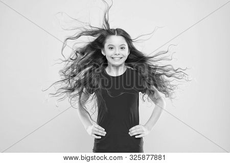 Things You Doing To Damage Your Hair. Girl Adorable Kid Long Wavy Hair Yellow Background. Wind Can A