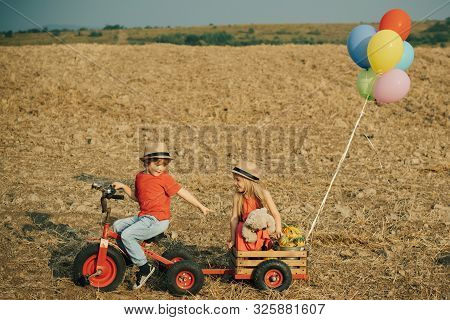 Children Planting In Ground. Happy Little Farmers Having Fun On Field. Cute Little Farmers - Sister 