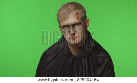Executioner Halloween Man Portrait. Guy With Dripping Blood On His Face. Executioner, Headman Makeup