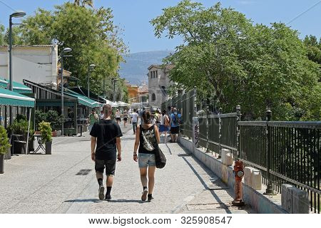 Athens, Greece - August 4, 2016: People Walking By The Cafes And The Museum Of The Ancient Agora In 