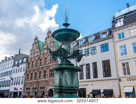 Copenhagen, Denmark - May 04, 2019: Amagertorv Square. Stork Fountain And On The Background Mathias 