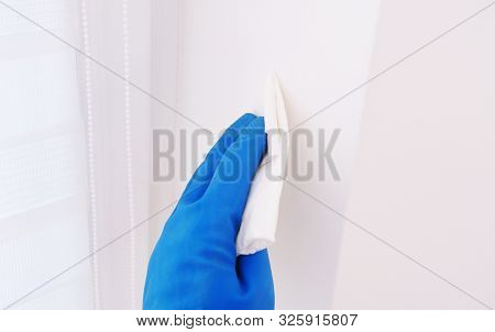 Disinfection In Public Places, The Fight Against The Virus, Coronavirusthe Worker's Hand Wipes The W