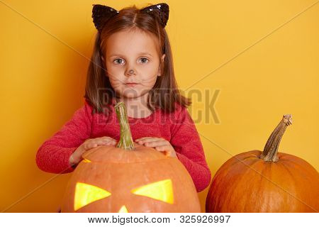 Portrait Of Adorable Funny Caucasian Little Girl Dressed Red Shirt With Orange Halloween Pumpkin. Ch