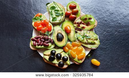 Top View Avocado Vegetarian Sandwich Top View With Fresh Sliced Avocados Round Plate, On Black Copy 