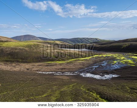 Colorful Rhyolit Mountain Panorma With Snow Fiields And Multicolored Volcanos In Landmannalaugar Are