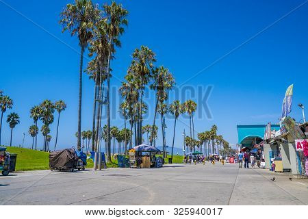 June 10, 2019. Los Angeles, Usa. Venice Beach Broadwalk View In California With Palm Trees And Clear