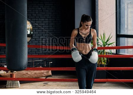 Attractive Sports Caucasian Girl Leaned On The Ropes On Boxing Ring, Have A Rest After Intensive Wor