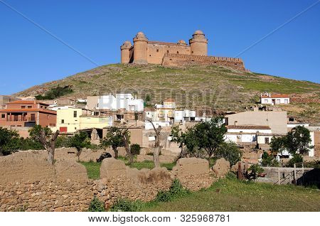 La Calahorra, Spain - May 5, 2010 - View Of The Castle On The Hilltop With Town Buildings In The For