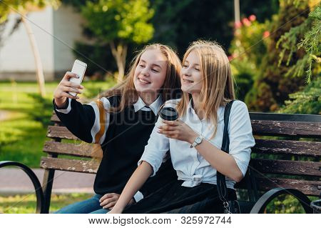 Happy Brightful Positive Moments Of Two Stylish Girls Hugging On Street In City. Closeup Portrait Fu