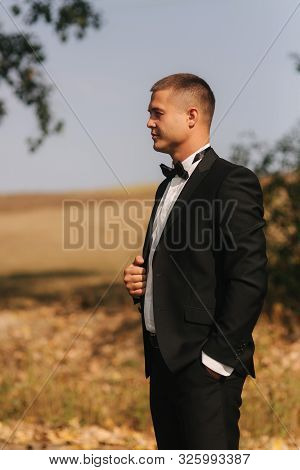 Handsome Groomm Dressed A Tie Bow. Wedding Day. Man Outside. Young Man Smile
