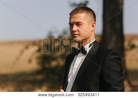 Handsome Groomm Dressed A Tie Bow. Wedding Day. Man Outside. Young Man Smile