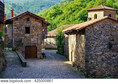 Ancient Stone Houses And Catholic Church Tower In Mountain Village. Barcena Mayor.