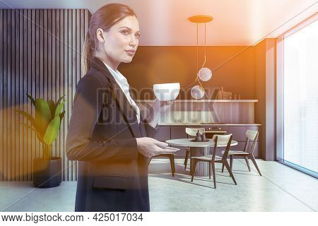 Attractive Businesswoman In Formal Suit Is Drinking Coffee At Corporate Office Kitchen. Modern Kitch